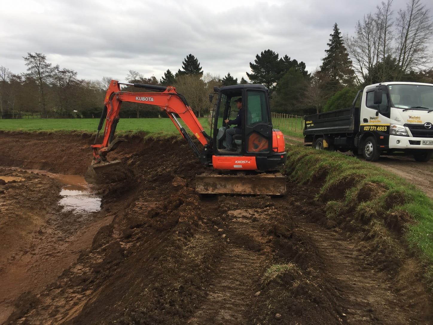 Excavator carrying out commercial drainage groundwork in Hamilton