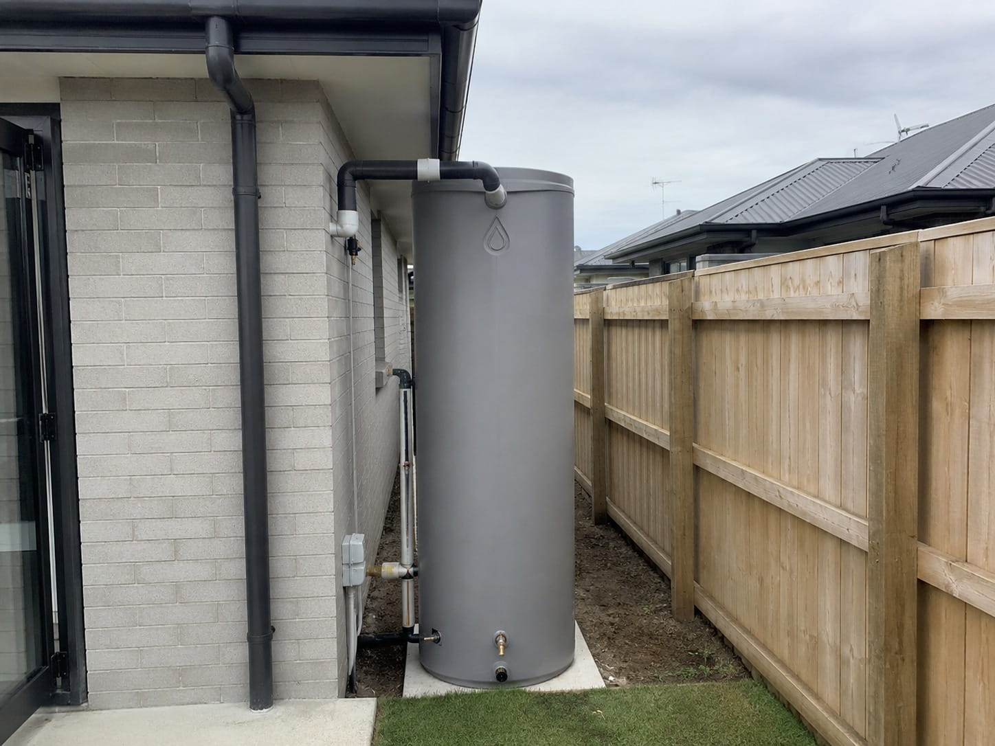 Concrete and plastic water tank plumbing connection